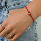red cord bracelet