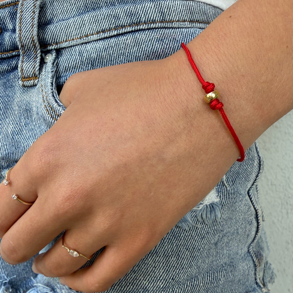 red cord bracelet