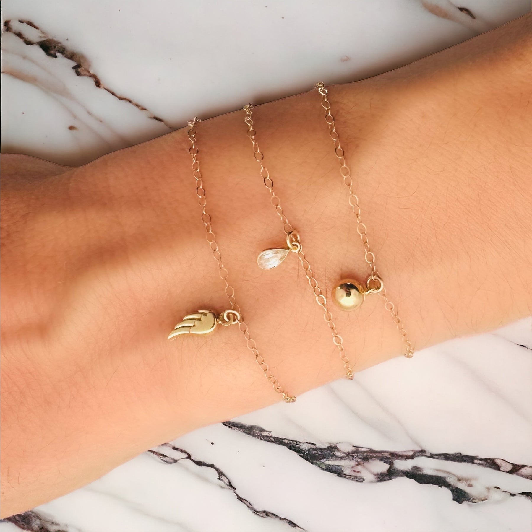 Angel Wing Charm Bracelet by Becket & Quill, handmade in Los Angeles - detail view