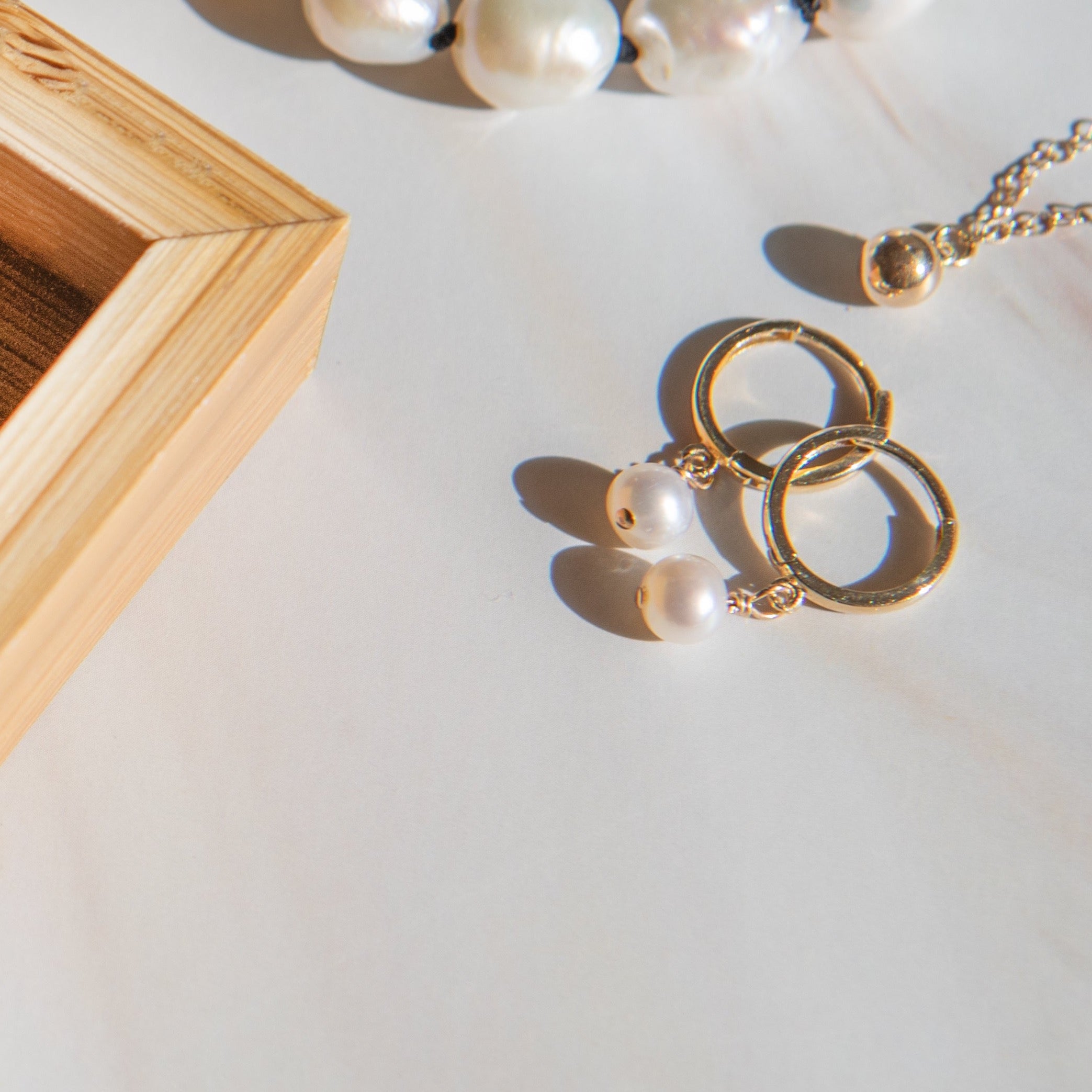 Pearl Huggies by Becket & Quill, handmade in Los Angeles - worn close-up