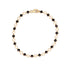 A gold filled chain bracelet featuring alternating black enamel clover shaped and small open clover  links, with a lobster clasp closure
