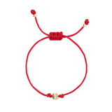 Red macrame bracelet with gold filled bead on a white background