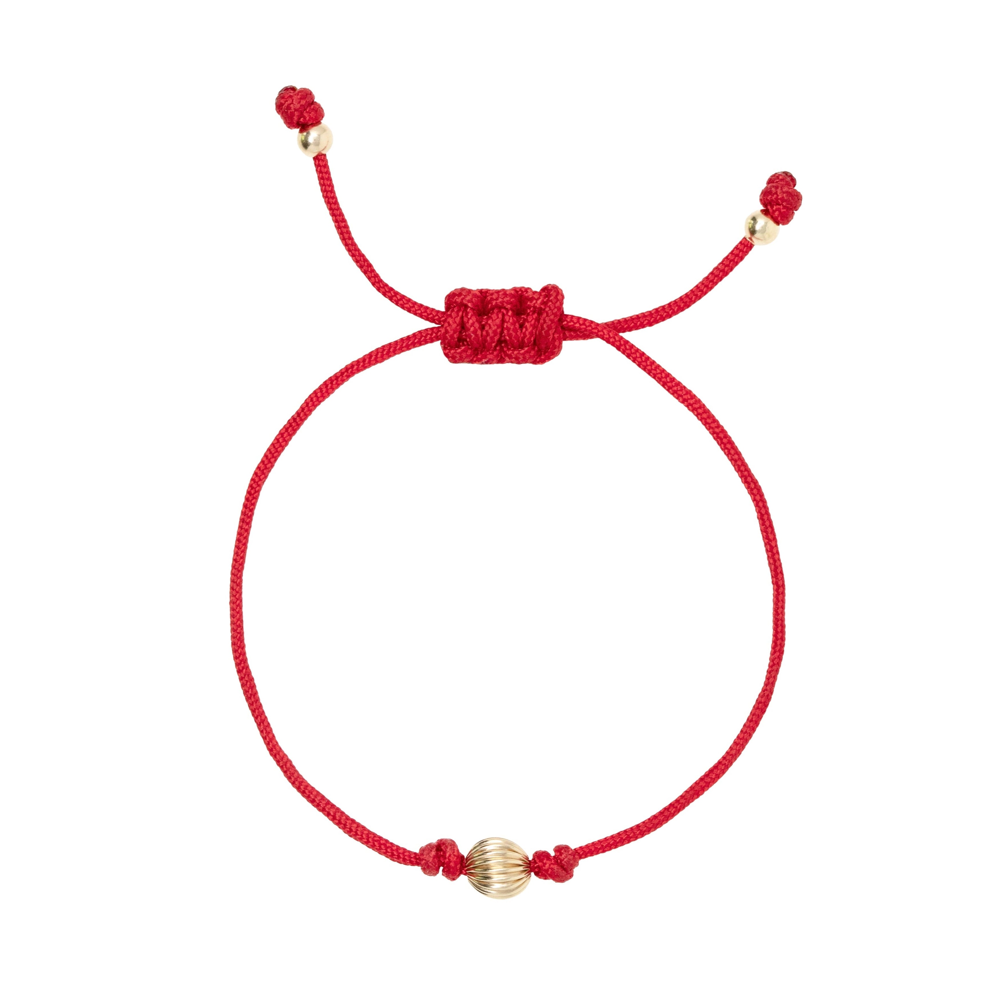 Red macrame bracelet with gold filled bead on a white background