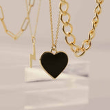 Black Enamel Heart Necklace by Becket & Quill, handmade in Los Angeles - worn close-up